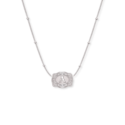 Gold necklace with a decorative pendant on a white background