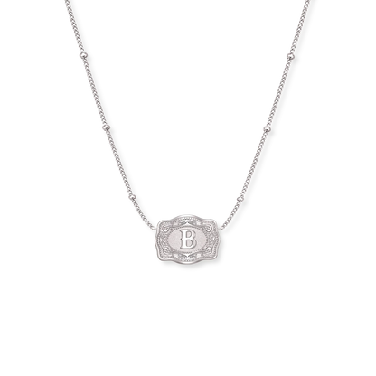 Gold necklace with a decorative pendant on a white background